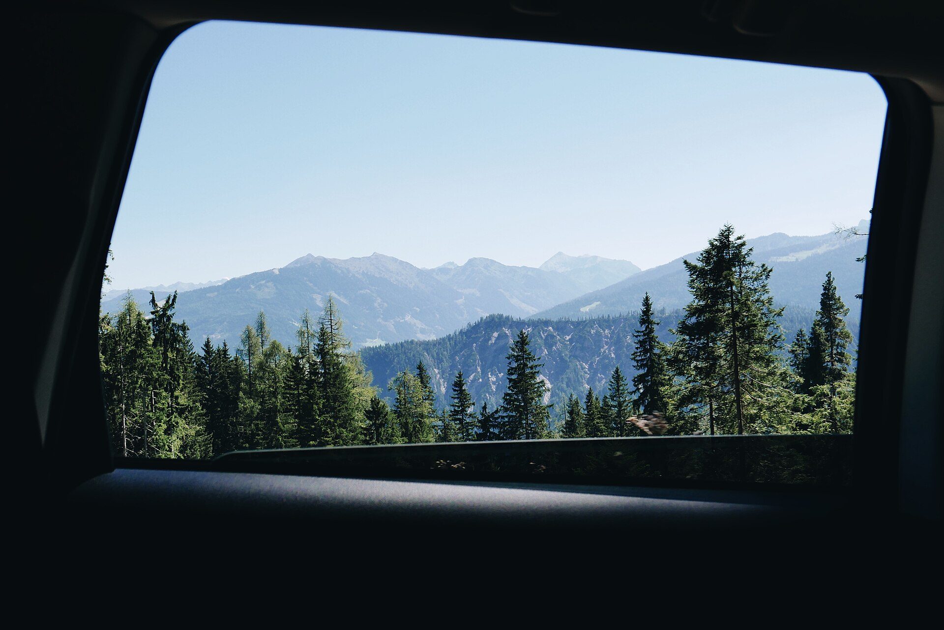 Mountain view through a car rear window