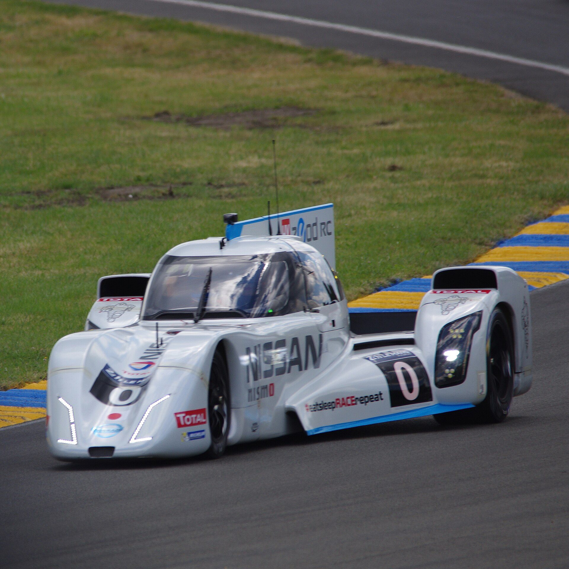 White prototype race car on track at Le Mans